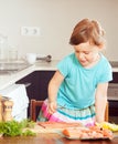 Baby girl cooking salmon Royalty Free Stock Photo
