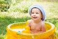 Baby girl in Cotton Panama Cap bathes in Inflatable Swimming Pad