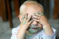 Baby Girl COvering Messy Face with Little Hands Royalty Free Stock Photo