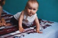 Baby girl crawling at bed in living room Royalty Free Stock Photo