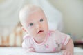 The baby girl crawls on the white bed Royalty Free Stock Photo