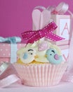 Baby girl cupcake with cute birds and ribbon closeup Royalty Free Stock Photo