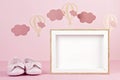 Baby girl cute pink shoes over the pink pastel background with clouds and ballons Royalty Free Stock Photo