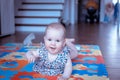 Baby girl doing tummy time on colorful play mat Royalty Free Stock Photo