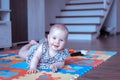 Baby girl doing tummy time on colorful play mat Royalty Free Stock Photo