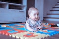 Baby girl doing tummy time on colorful play mat Royalty Free Stock Photo