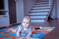 Baby girl doing tummy time on colorful play mat Royalty Free Stock Photo