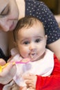 Baby girl eating food for first time Royalty Free Stock Photo