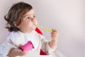 Baby girl eating yogurt with messy face Royalty Free Stock Photo