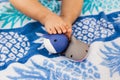 Baby girl feet with rubber toys on summer towel as a background Royalty Free Stock Photo