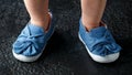 Baby girl first blue denim shoes with bow Royalty Free Stock Photo