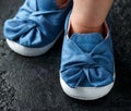 Baby girl first blue denim shoes with bow Royalty Free Stock Photo