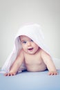 Baby girl gasping in surprise under a towel Royalty Free Stock Photo