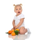 Baby girl happy sitting smilling screaming with fresh orange man Royalty Free Stock Photo