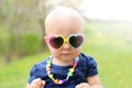 Baby Girl With Heart Shaped Sunglasses Outside