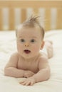 Baby girl on her stomach. Newborn baby on tummy, skin care, health care Royalty Free Stock Photo