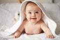 Baby girl is hiding under the white blanket. Royalty Free Stock Photo