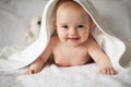 Baby girl is hiding under the white blanket. Royalty Free Stock Photo