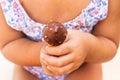 A baby girl holding a chocolate dipped ice cream cone in her hands Royalty Free Stock Photo