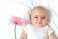 Baby girl holding a flower