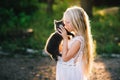Baby girl holding hands a kitten in the light of sunset Royalty Free Stock Photo