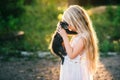 Baby girl holding hands a kitten in the light of sunset Royalty Free Stock Photo