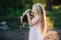 Baby girl holding hands a kitten in the light of sunset Royalty Free Stock Photo