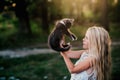 Baby girl holding hands a kitten in the light of sunset Royalty Free Stock Photo