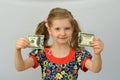 Baby girl holds in hands a torn banknote ,dollar ,banking crisis. Royalty Free Stock Photo