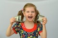 Baby girl holds in hands a torn banknote ,dollar ,banking crisis. Royalty Free Stock Photo