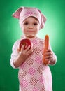 The baby girl with a kerchief and kitchen apron holding an vegetable isolated Royalty Free Stock Photo