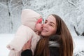 Baby girl kisses mom on the cheek Royalty Free Stock Photo