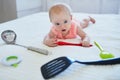 Baby girl with kitchen utensils Royalty Free Stock Photo