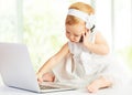 Baby girl at laptop computer, mobile phone Royalty Free Stock Photo