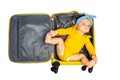 Baby girl lay in empty travel hand luggage suit Royalty Free Stock Photo