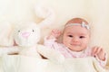 Baby girl laying on her blanket with her stuffed bunny Royalty Free Stock Photo