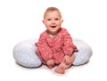 Baby girl learning to sit using a pillow Royalty Free Stock Photo