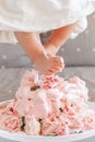 baby girl legs feet stepping in cake during her birthday celebration