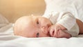 Little baby girl lies on belly on parent bed Royalty Free Stock Photo