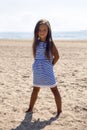 Baby girl with long hair in striped blue dress Royalty Free Stock Photo