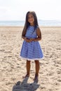 Baby girl with long hair in striped blue dress Royalty Free Stock Photo