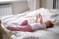 baby girl looking animated cartoon , educational program on phone on bed at home Royalty Free Stock Photo