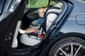 Baby girl looking through car window. little girl sitting in a child seat in the car