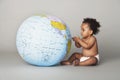 Baby Girl Looking At Inflatable Globe Royalty Free Stock Photo