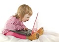 Baby girl looking onto the laptop's screen Royalty Free Stock Photo