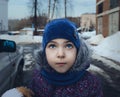 The baby girl looks to the top, winter weather, the onset of spring, selective focus. The concept of children and parents