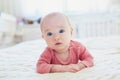 Baby girl lying on bed and smiling Royalty Free Stock Photo