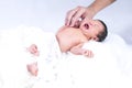 A baby girl is lying on a soft mattress. The baby is crying on the mattress Royalty Free Stock Photo