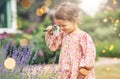 baby girl with magnifier looking at garden flowers Royalty Free Stock Photo