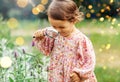 baby girl with magnifier looking at garden flowers Royalty Free Stock Photo